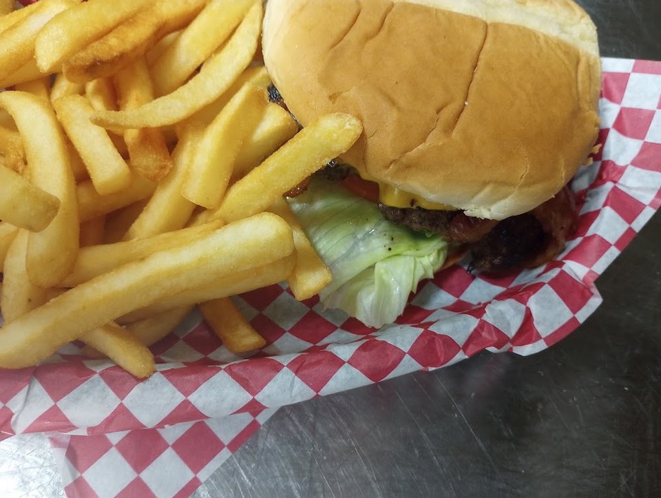 Printed menu featuring burgers, salads, and subs.